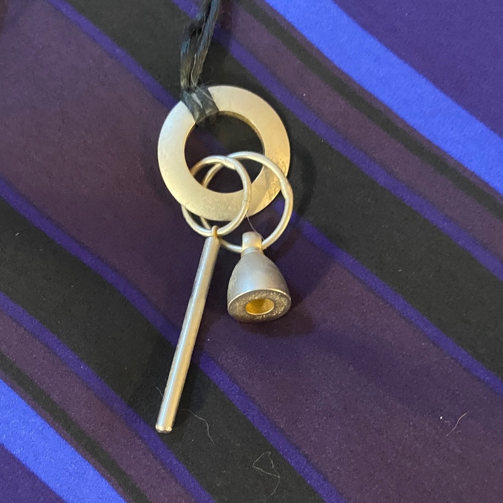 3/$15. Modern Gold and Silver Pendant Necklace on a black cord.